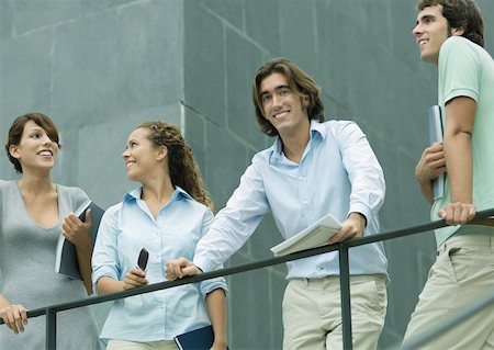 Casually dressed young executives standing next to railing, low angle view Stock Photo - Premium Royalty-Free, Code: 632-01157530