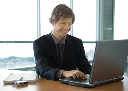 email us - Businessman working on laptop Stock Photo - Premium Royalty-Free, Code: 632-01157599