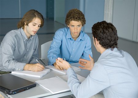 simsearch:632-01148350,k - Three young business men working at table Foto de stock - Royalty Free Premium, Número: 632-01157694