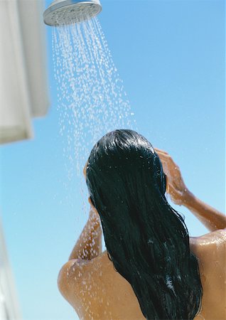 Woman taking shower outdoors, rear view Stock Photo - Premium Royalty-Free, Code: 632-01158610