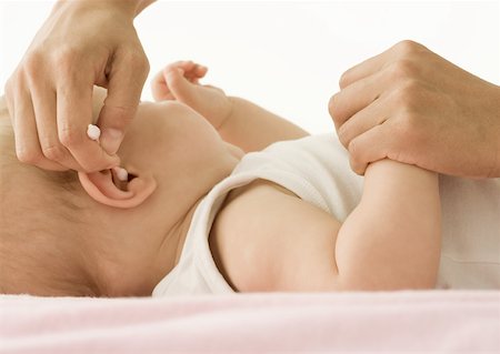 Baby having ear cleaned Stock Photo - Premium Royalty-Free, Code: 632-01158720