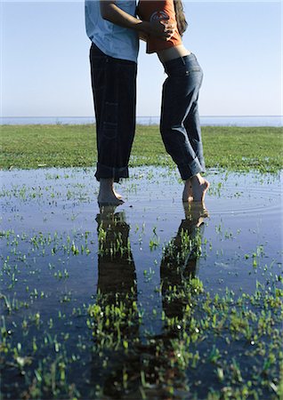 simsearch:632-01150072,k - Young couple standing in puddle passionately embracing Stock Photo - Premium Royalty-Free, Code: 632-01150054