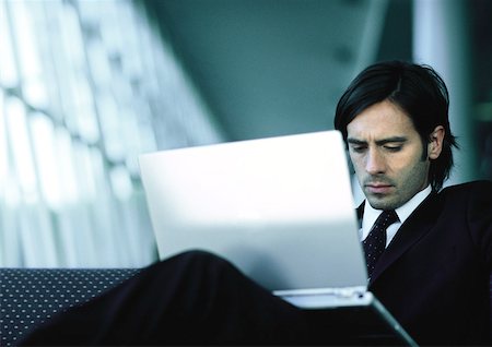 Businessman sitting, working on laptop. Stock Photo - Premium Royalty-Free, Code: 632-01150104