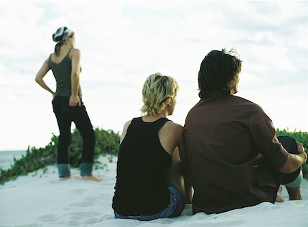 simsearch:696-03402108,k - Couple sitting and woman standing on sand dune, rear view Stock Photo - Premium Royalty-Free, Code: 632-01150308