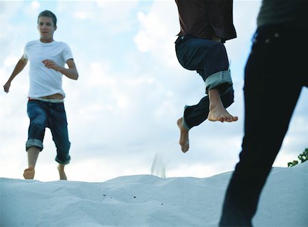 running sand dune - People running down sand dune, close-up Stock Photo - Premium Royalty-Free, Code: 632-01150302