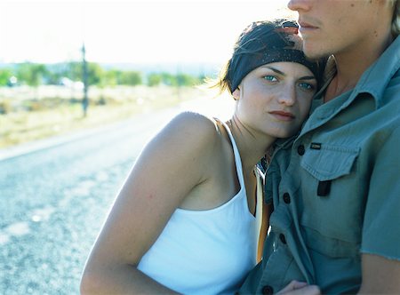 exhausted man on the road - Couple hugging, woman looking at camera Stock Photo - Premium Royalty-Free, Code: 632-01150319