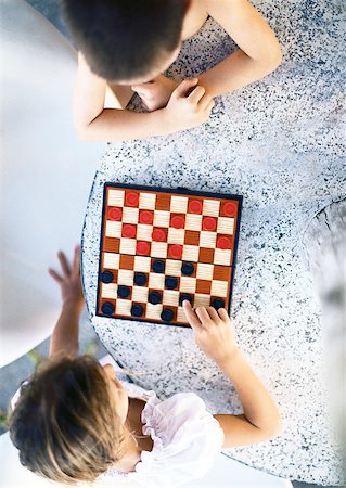 Two children playing checkers, view from directly above Stock Photo - Premium Royalty-Free, Code: 632-01150364