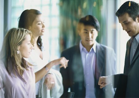 Group of businesspeople checking time Stock Photo - Premium Royalty-Free, Code: 632-01152623