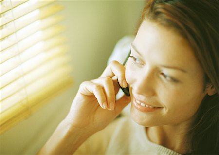 simsearch:632-02745019,k - Woman using cell phone, looking out window, close-up Stock Photo - Premium Royalty-Free, Code: 632-01152651