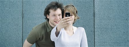 Young couple taking self portrait with camera phone Stock Photo - Premium Royalty-Free, Code: 632-01152716