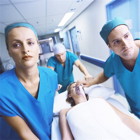 doctors pushing patient - Medical team moving patient on gurney Stock Photo - Premium Royalty-Free, Code: 632-01152806