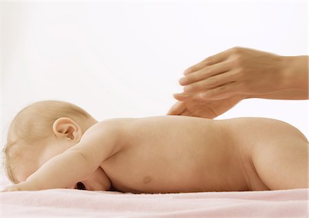 Mother rubbing baby's back, cropped view Stock Photo - Premium Royalty-Free, Code: 632-01153289