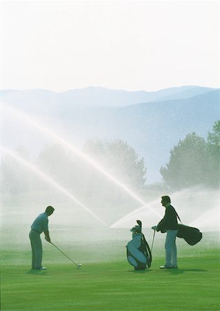 photo adults in sprinklers playing - Golfers golfing among sprinklers Stock Photo - Premium Royalty-Free, Code: 632-01153335