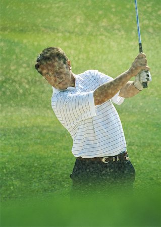 simsearch:6113-07159201,k - Golfer swinging with sand flying Foto de stock - Sin royalties Premium, Código: 632-01153350