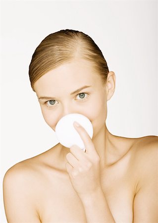 simsearch:632-05553628,k - Woman holding up cotton pad in front of mouth Stock Photo - Premium Royalty-Free, Code: 632-01153397