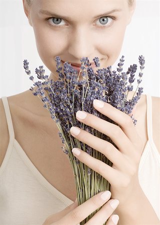 person smelling lavender - Woman smelling bunch of lavender, looking at camera Stock Photo - Premium Royalty-Free, Code: 632-01153528