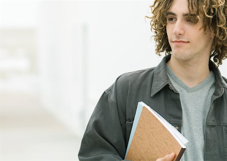 Young man holding notebooks Stock Photo - Premium Royalty-Free, Code: 632-01153546