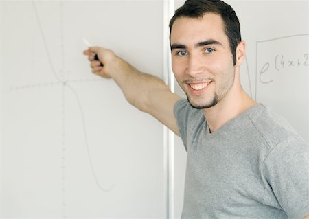 Young man writing on whiteboard Stock Photo - Premium Royalty-Free, Code: 632-01153547