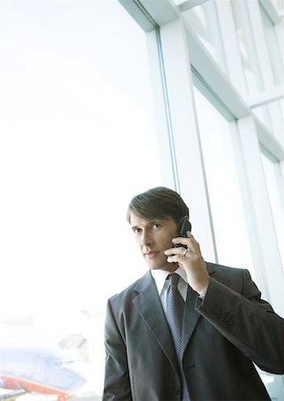 simsearch:695-03388701,k - Businessman using cell phone in airport Stock Photo - Premium Royalty-Free, Code: 632-01160331