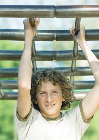 dangling teenage - Teenage boy hanging from bars Stock Photo - Premium Royalty-Free, Code: 632-01161533