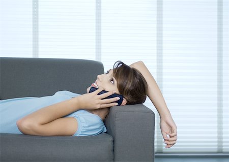 simsearch:632-02745019,k - Woman lying on sofa, talking on phone Stock Photo - Premium Royalty-Free, Code: 632-01194087