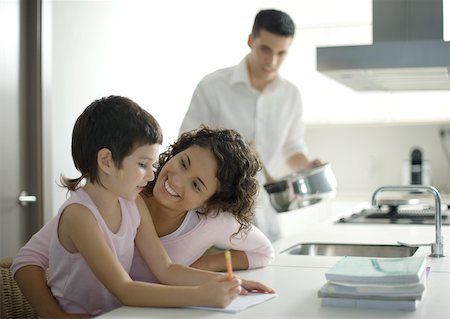 Mother helping child with homework Stock Photo - Premium Royalty-Free, Code: 632-01193793