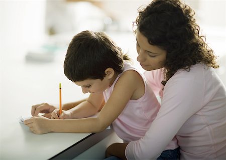 Mother helping child with homework Stock Photo - Premium Royalty-Free, Code: 632-01193815