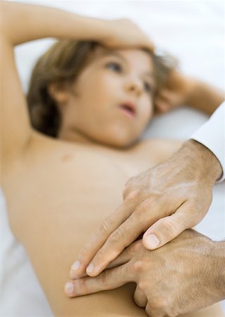 photo of a white boy on sick bed - Doctor feeling boy's stomach Stock Photo - Premium Royalty-Free, Code: 632-01193839