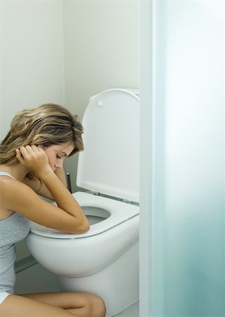 simsearch:695-05764382,k - Young woman sitting next to toilet Stock Photo - Premium Royalty-Free, Code: 632-01193851