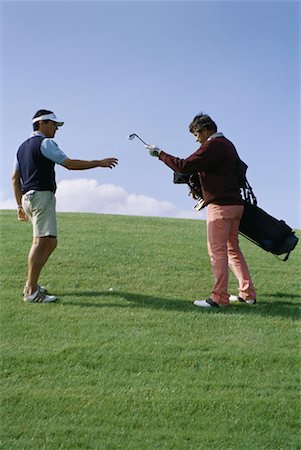 simsearch:632-01153250,k - Caddy handing golfer golf club Stock Photo - Premium Royalty-Free, Code: 632-01234640