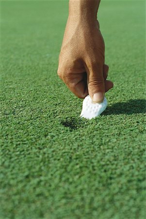 simsearch:632-01234708,k - Golfer using divot repair tool on turf, close-up of hand Foto de stock - Sin royalties Premium, Código: 632-01234713