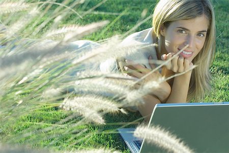 simsearch:632-03847818,k - Young woman lying in field with laptop Stock Photo - Premium Royalty-Free, Code: 632-01276608