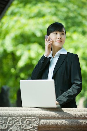 simsearch:632-01271089,k - Young woman using laptop and cell phone Stock Photo - Premium Royalty-Free, Code: 632-01276974