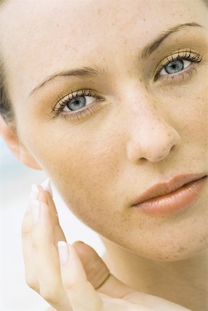 dabbing - Woman applying sunscreen to face, close-up Stock Photo - Premium Royalty-Free, Code: 632-01277101