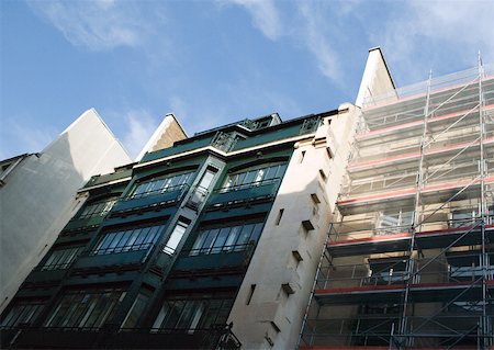 photo of civil engineering scaffolding - Apartment buildings, one with scaffolding, low angle view Stock Photo - Premium Royalty-Free, Code: 632-01277405