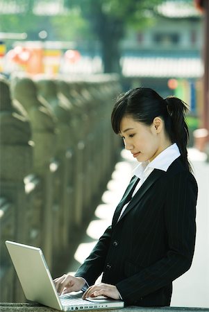 simsearch:632-01271089,k - Young woman using laptop Stock Photo - Premium Royalty-Free, Code: 632-01277429