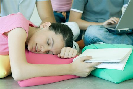 sleeping on floor - Teenage friends, teen girl holding book, resting head on cushion Stock Photo - Premium Royalty-Free, Code: 632-01277486