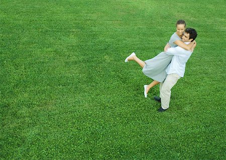 simsearch:632-03779625,k - Man swinging woman in his arms, full length, high angle view Stock Photo - Premium Royalty-Free, Code: 632-01270489