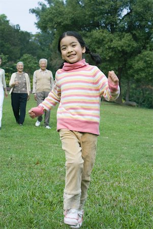 simsearch:633-01714195,k - Girl dancing while family watches in background Stock Photo - Premium Royalty-Free, Code: 632-01270659