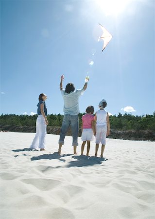 Family flying kite on beach Stock Photo - Premium Royalty-Free, Code: 632-01271125