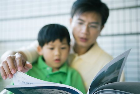 simsearch:696-03401226,k - Father and son looking at book together Stock Photo - Premium Royalty-Free, Code: 632-01271133