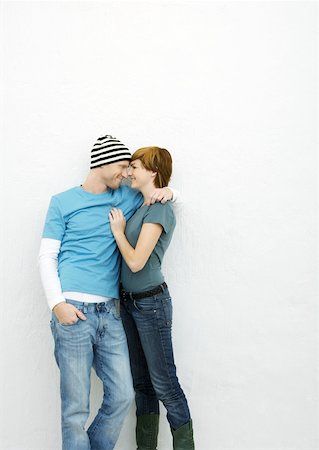 Young couple standing face to face, smiling at each other, three quarter length Stock Photo - Premium Royalty-Free, Code: 632-01271210