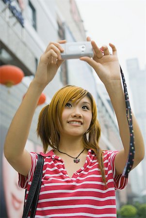 Teenage girl taking photo with cell phone Stock Photo - Premium Royalty-Free, Code: 632-01271294