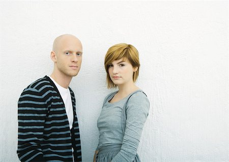 simsearch:695-05765084,k - Young couple, looking at camera, portrait, white background Stock Photo - Premium Royalty-Free, Code: 632-01271784