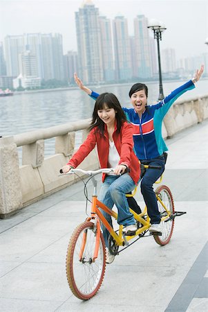 Two friends riding tandem bicycle Stock Photo - Premium Royalty-Free, Code: 632-01271839