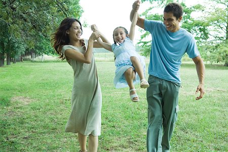 Family outdoors, parents swinging girl Stock Photo - Premium Royalty-Free, Code: 632-01379634