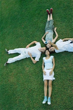 simsearch:693-06668076,k - Group of young friends lying on grass with heads together Stock Photo - Premium Royalty-Free, Code: 632-01380135