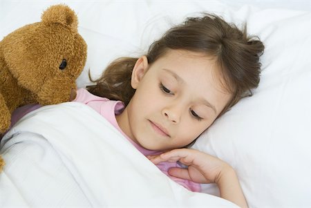 simsearch:632-01380299,k - Girl lying in bed with teddy bear Stock Photo - Premium Royalty-Free, Code: 632-01380263