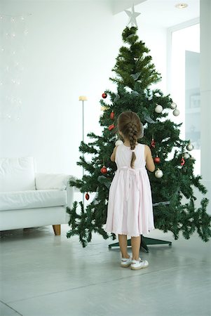 Girl decorating Christmas tree Stock Photo - Premium Royalty-Free, Code: 632-01380616