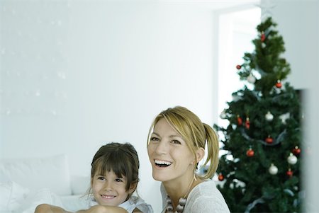 family laughing and relaxing on sofa - Woman and daughter in front of Christmas tree Stock Photo - Premium Royalty-Free, Code: 632-01380626